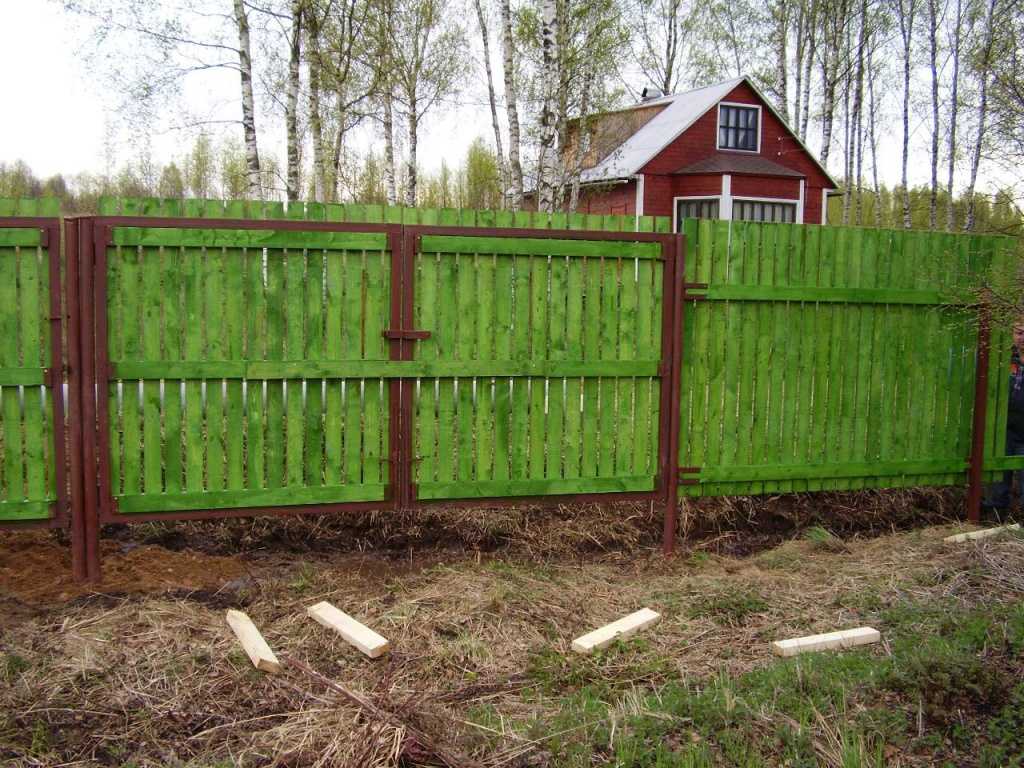 Забор для дачи какой дешевле. Забор на дачном участке. Заборы для дачных участков. Зеленый деревянный забор. Дешевый забор.